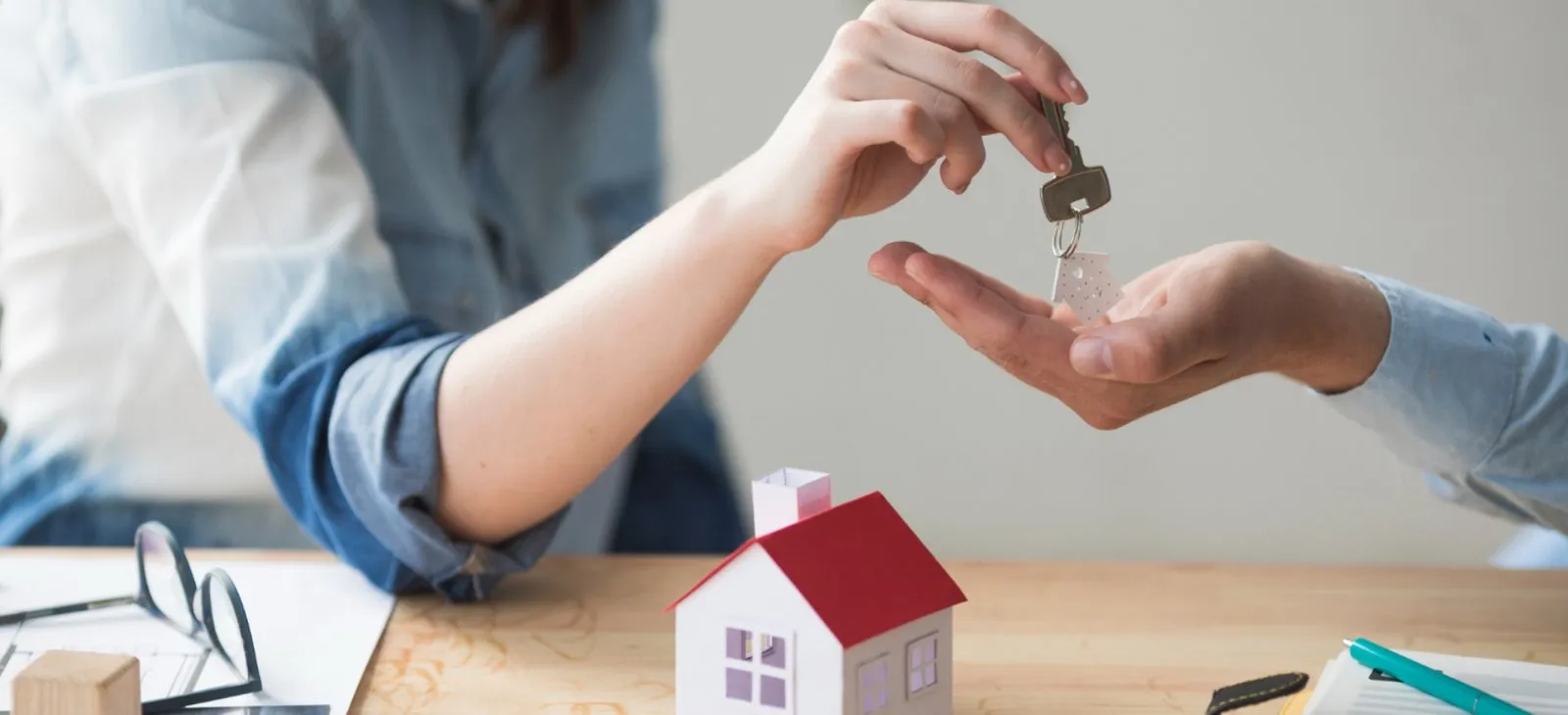 Adviser handing over keys for a home purchase